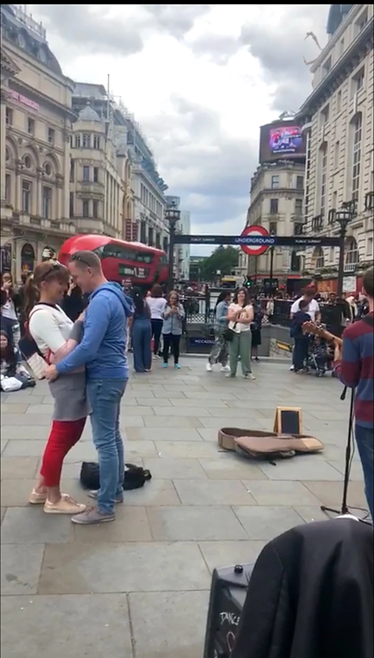 Agustin Kafka playing guitar during a marriage proposal